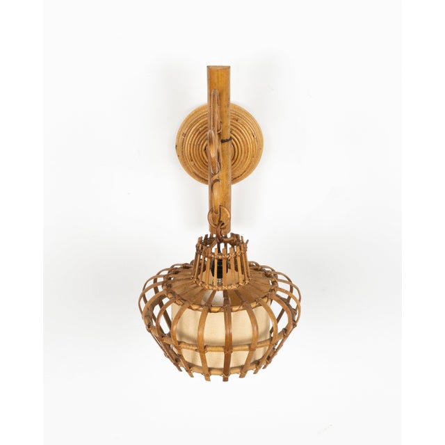 Midcentury beautiful sconce "Lantern" wall lamp in rattan and bamboo, in the style of Louis Sognot. Made in Italy in the...
