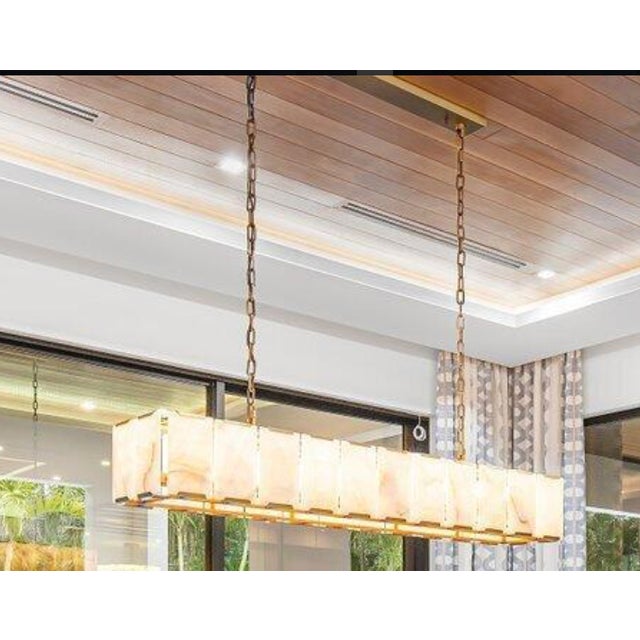 Translucent calcite is cut in sheer and faceted slabs, each held in place by a slender mount in RH's dramatic collection....