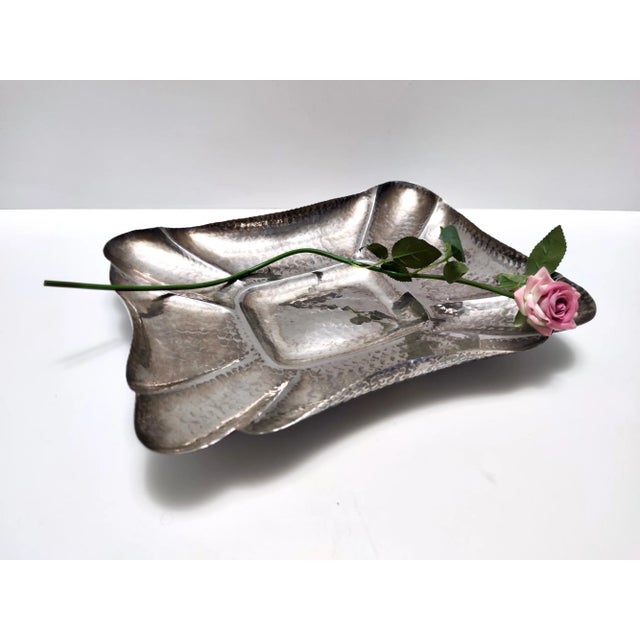 Made in Italy in 1950s. This tray / centerpiece is made in hand embossed silver plated metal. It is a vintage item,...