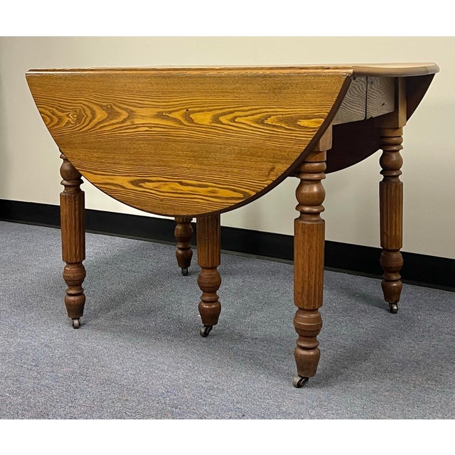 Great antique drop leaf extension dining table. Made of solid chestnut in the later part of the nineteenth century. The...