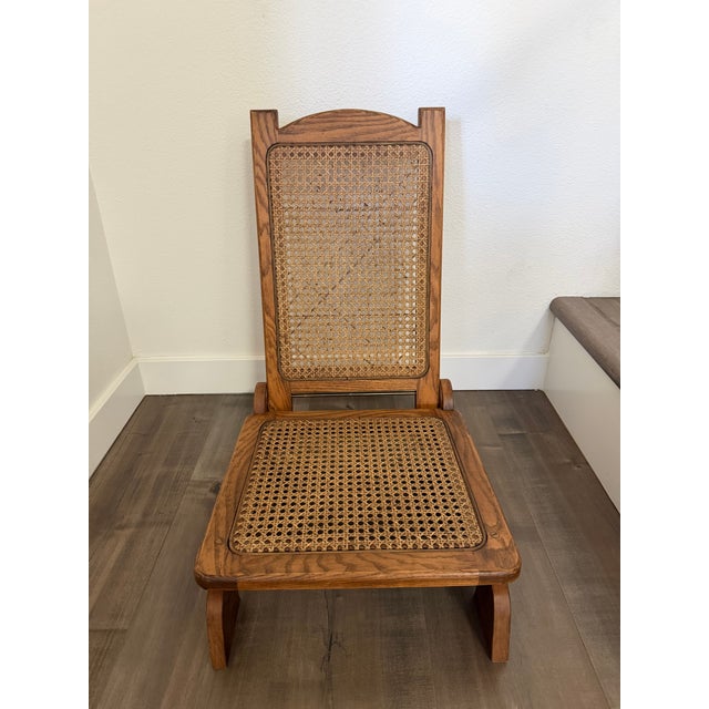 This is a pair of incredible antique folding “canoe” chairs. They are likely oak wood and have no visible screws. The cane...