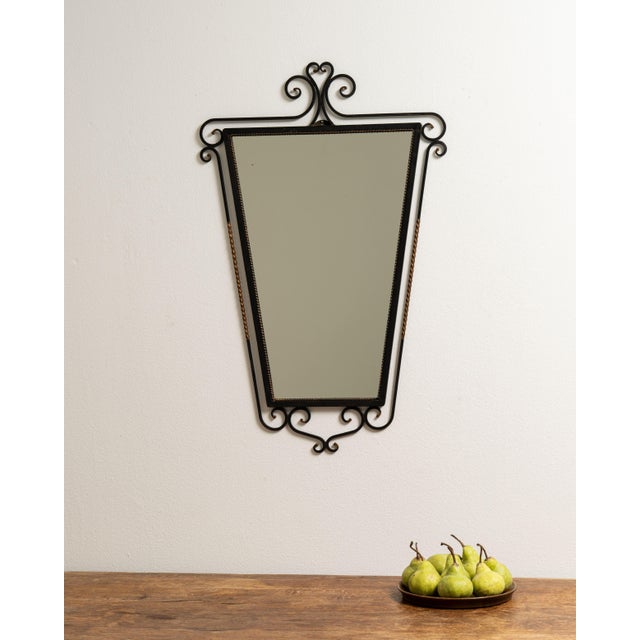 A series of mirrors featuring hand-worked iron frames. The designs range from simple to decorative, emphasizing...
