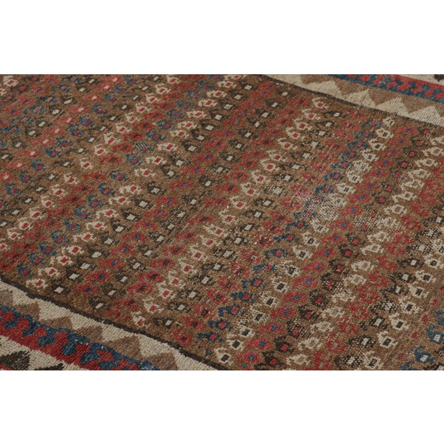 Hand-knotted in wool circa 1920-1930, this 4x5 antique Persian rug is a remarkable signature piece from our Antique...