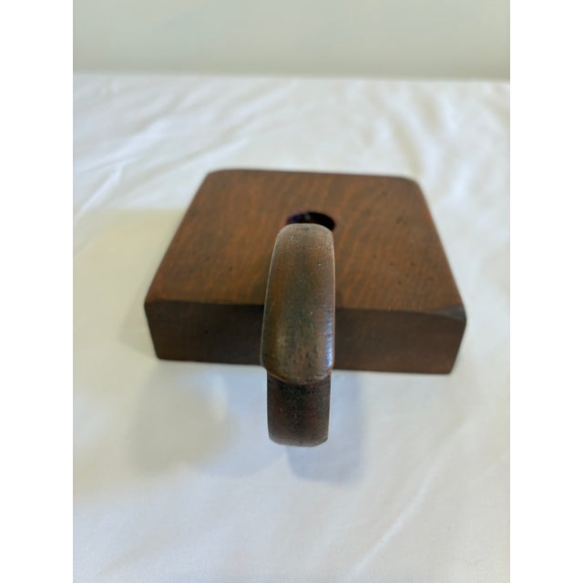A charming vintage wooden chamberstick-style candle holder featuring a distinctive sculptural handle and simple...