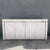 A striking postmodern credenza that exudes refined sophistication through its sculptural silhouette, soft lavender-toned...