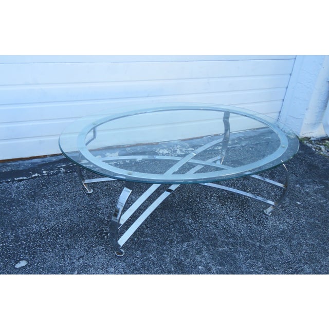 This highly elegant Coffee Table is made of metal and glass. This brilliantly modern coffee table has a classic Hollywood...