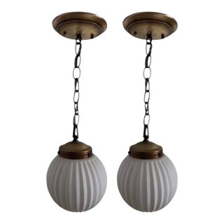 1950s Art Deco MCM Brass Gold Ribbed Round Frosted White Globe Pendant Lights Fixtures - A Pair For Sale