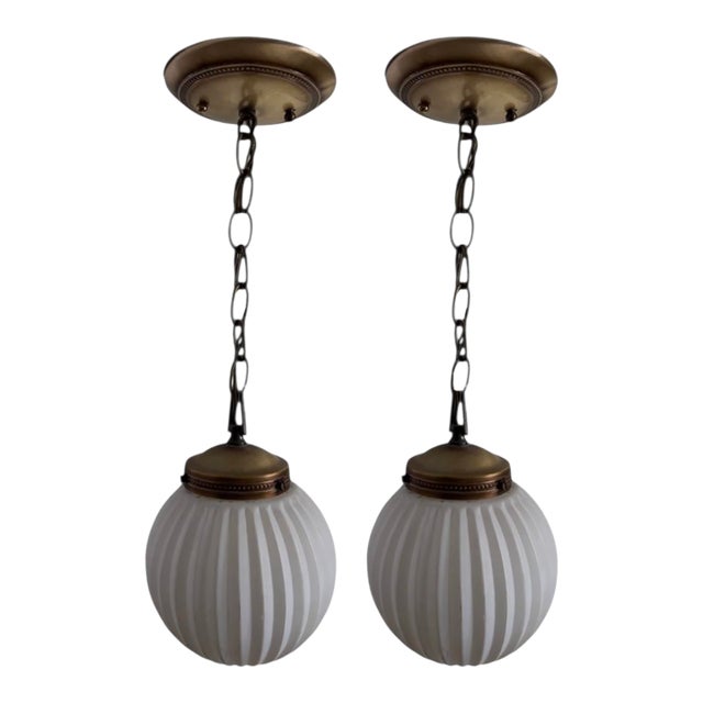 1950s Art Deco MCM Brass Gold Ribbed Round Frosted White Globe Pendant Lights Fixtures - A Pair For Sale