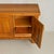 A French sideboard by Maison Regain, crafted in solid elm during the 1970s. The rectangular case is defined by flush panel...