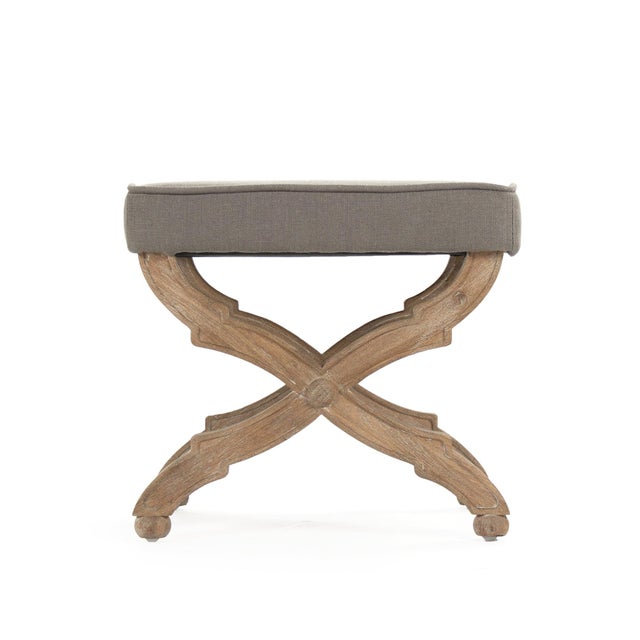 The Crescenzo Single Bench from Zentique is a compact, sculptural X-base stool with ornate carved and curved legs...