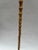 A single antique bamboo walking stick or cane with metal tip.