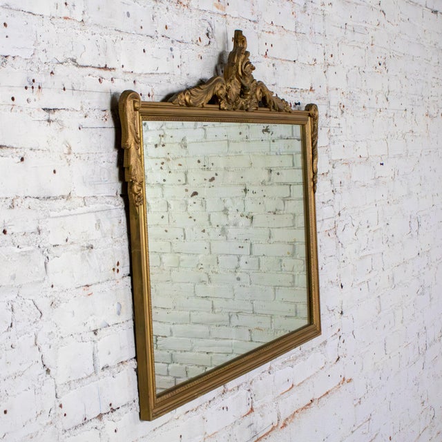 Magnificent vintage Baroque or Rococo style rectangular wall mirror composed of a gilded wood frame with hand carved and...