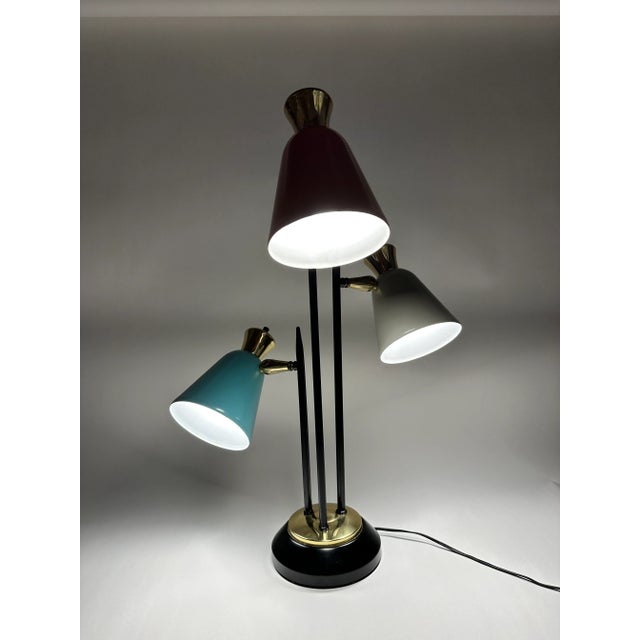 1950's French 3 arm table lamp. A trio of orange, blue and white metal shades with individual switches for each bulb.