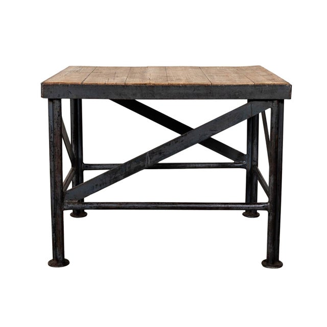 Metal and wood side table. Weathered wood top with metal base and legs.