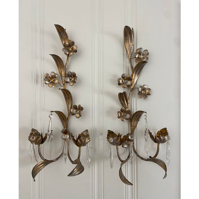 Absolutely. Beautiful pair of vintage mid century gilded wall sconces, made in Italy and in beautiful condition. The...