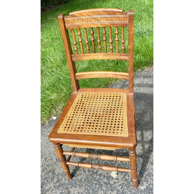 Offered are four half spindle, ball and stick, pressed back oak chairs with caned seats. Ball and stick was very popular...