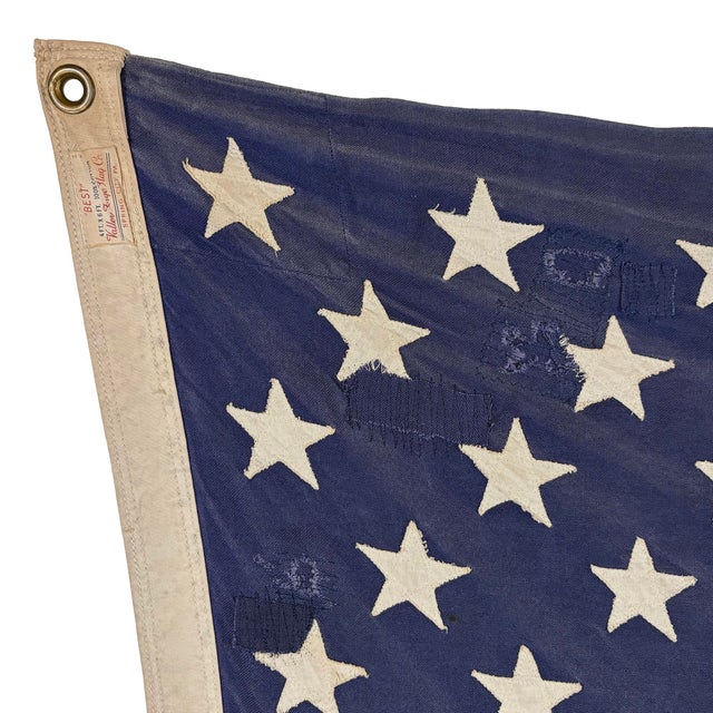 This large vintage American flag is made from a cotton cloth with fully sewn stars and stripes. Please note overall...