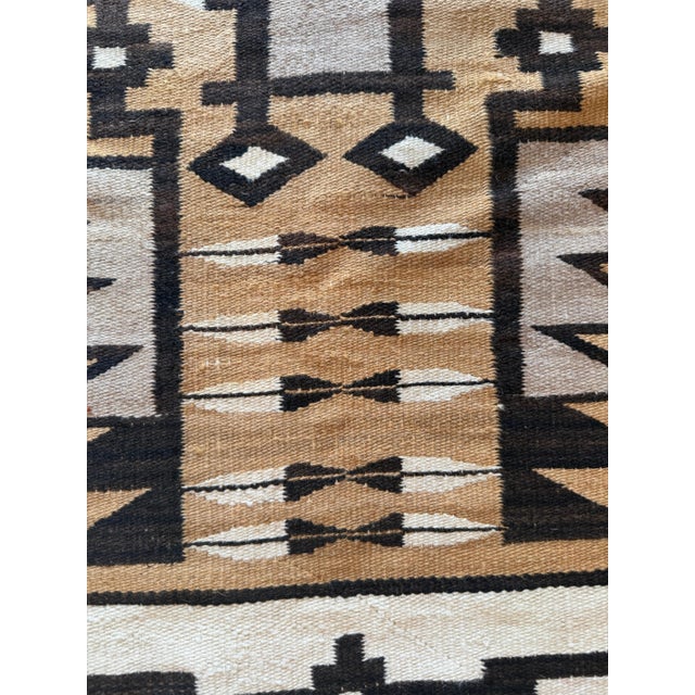 This striking 1920 period Navajo rug, measuring 3'6" x 4'9", is a classic example of early 20th-century American Southwest...
