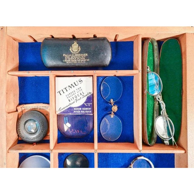 Collection of glasses and vintage accessories, in display case. one of the models is a bausch & lomb from the early 1900s...