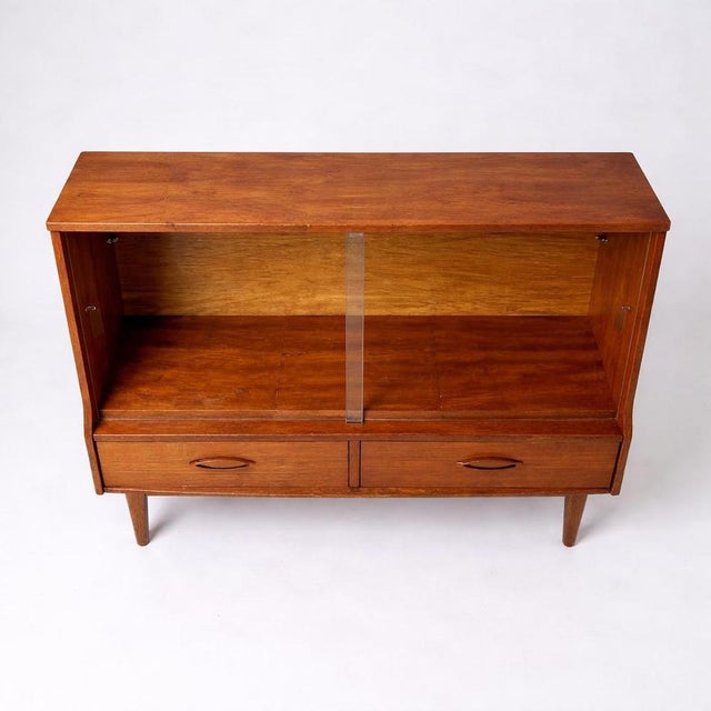 A beautifully designed mid-century teak low display cabinet by Jentique, showcasing the brand’s signature blend of...