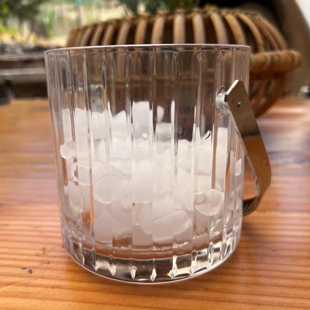 For your consideration, a fine clear lead cryst Ice Bucket with stainless steel handle. Attributed by the prestigious...