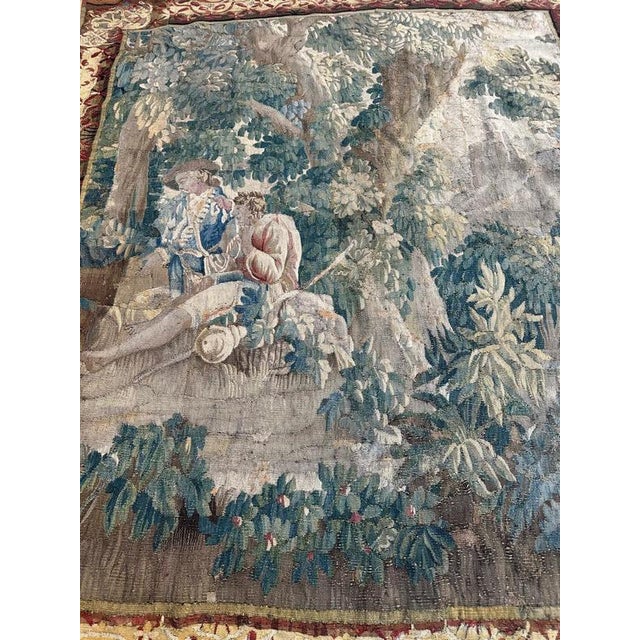 Beautiful 18th-century french Aubusson fragment tapestry depicting an elegant scene of two people rest set in the heart of...
