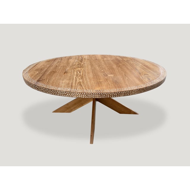 Impressive reclaimed teak wood dining table with added shell inlay on the top section and the edge. Floating on a...