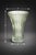 A beautifully sculpted vintage green glass vase featuring a fluted, ribbed form and softly scalloped rim. Part of our...