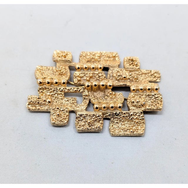 Modernist goldtone textured square and rectangular sections with lines of goldtone balls brooch with security clasp....