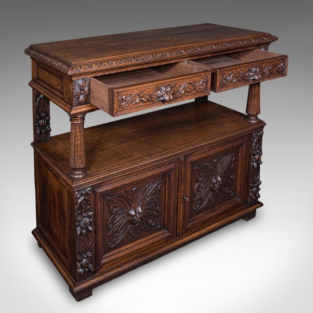 This is a large antique buffet. A Scottish, carved oak server or sideboard with Gothic revival taste, dating to the late...