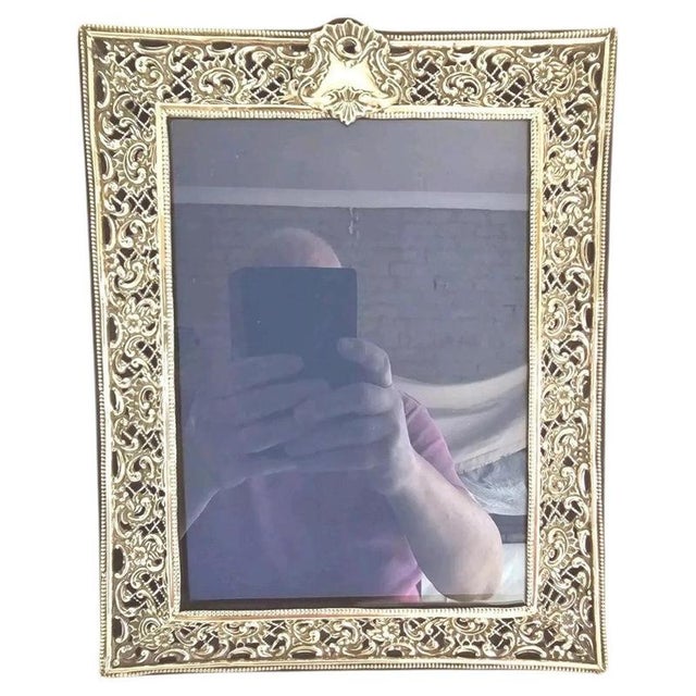A fine late Victorian photograph frame featuring an extensively decorated sterling silver mount, hallmarked Birmingham...