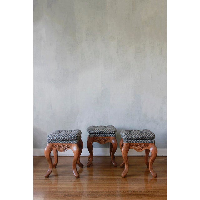 A set of three solid wooden footstools in excellent condition with well-maintained fabric. Crafted around 1880 in...