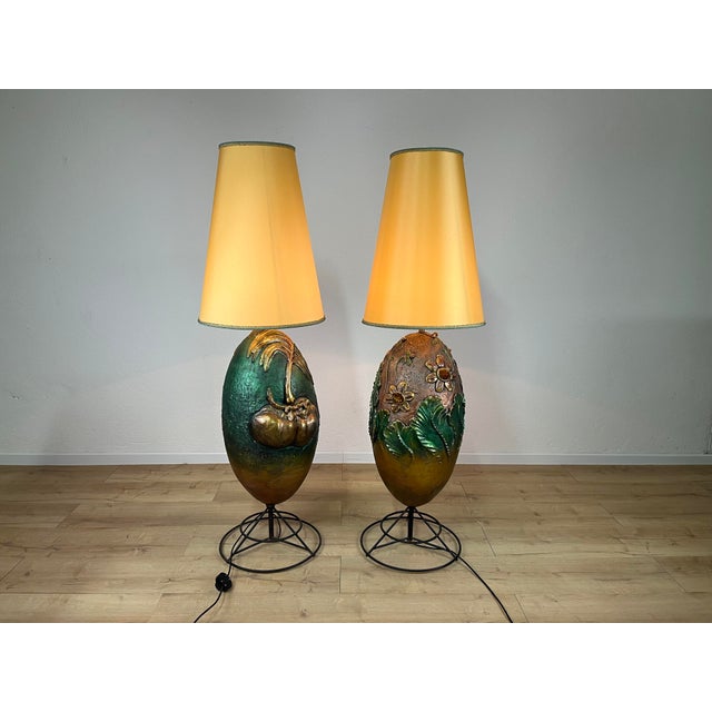 A pair of highly decorative, colored terracotta floor lamps with floral motifs, made in Italy in the 1980s. The lamps have...