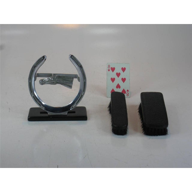 This product is a unique and stylish brush featuring a horse head design, made of Chromed Bronze with real hair accents....