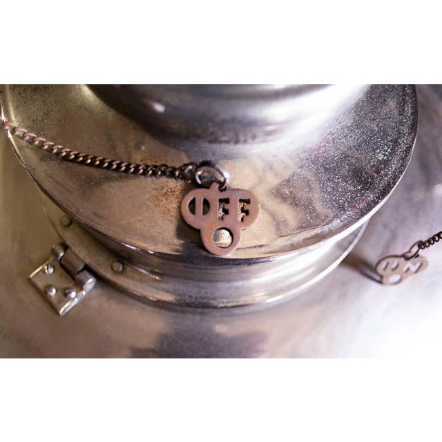 Late 20th century, Mid-Century Modern style, nickel plated pendant ceiling fixture. This unique light has two arms with...