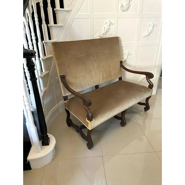 Antique Victorian French quality carved walnut settee upholstered in a quality fabric. Solid walnut-shaped reeded carved...