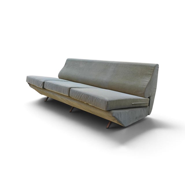 This sofa bed, featuring a refined sage green color, reflects the style and design typical of Marco Zanuso's work for...
