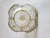 Gilded art glass basket with scalloped rim and ornate gold-tone handle. Translucent green and white textured glass is...