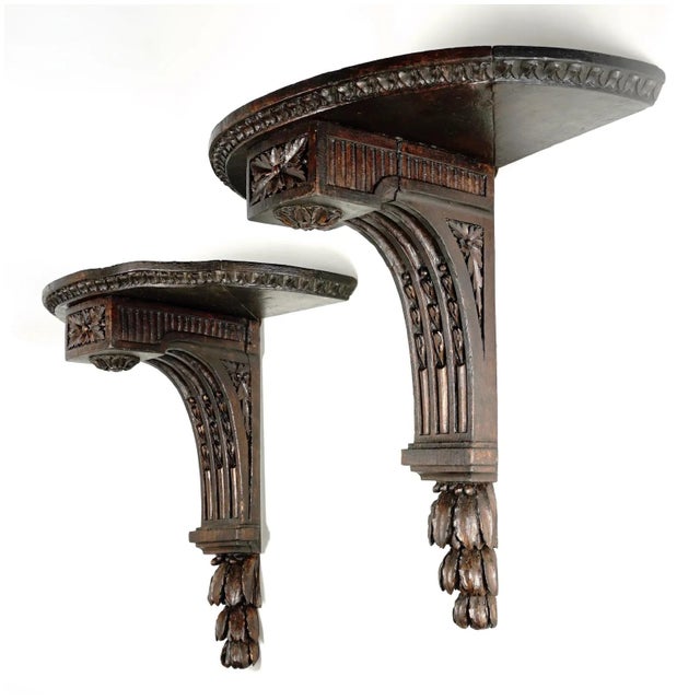 Pair of antique early 19th century French Neoclassical corbel wall shelves with demilune top with gadroon edging. Carved...