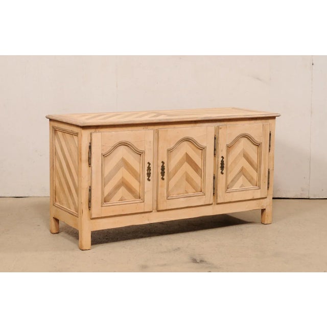 A French wooden buffet cabinet from the mid 20th century. This vintage French sideboard, approximately 5.75 feet in...