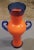 Up for sale is a 2001 Ipso Facto Art Glass Contemporary Style Orange/Blue Double Handled Vase! It measures 13 3/4” tall....