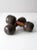 This is a pair of antique wooden dumbbells. The 19th century wood hand weights feature exaggerated black toned end...