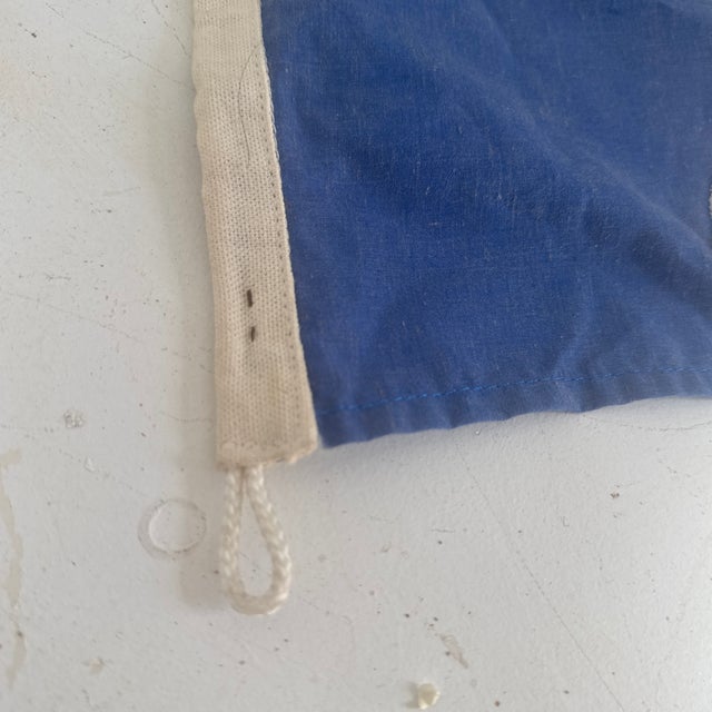 This is a vintage nautical flag of/From St. Lucia. It is a weathered cotton that is machine stitched in gold, black and...