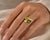 18k Hand fabricated, yellow gold ring featuring a 2.36 carat and 2.63 carat chrysoberyl Accented with 8 round brilliant...