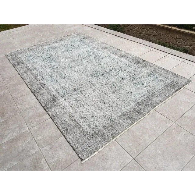 This is a vintage Turkish Oushak rug from the 1960s. The piece was hand-knotted