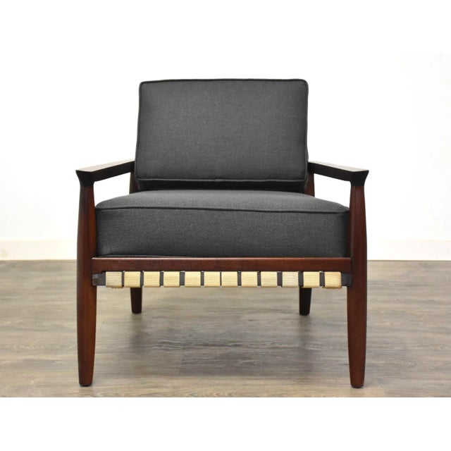 A beautiful solid mahogany mid century modern lounge chair with exposed straps and new dark charcoal grey upholstry. Seat...
