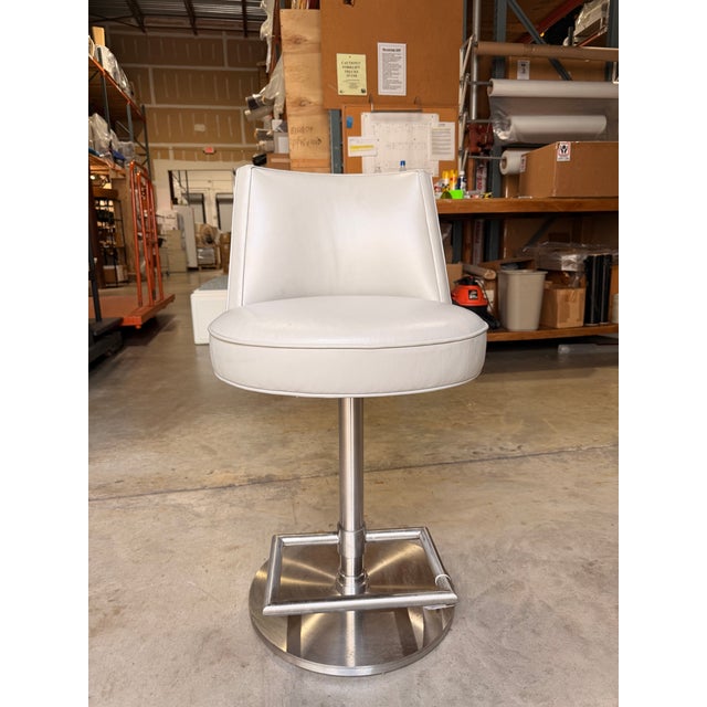 Contemporary Vanguard - unmarked - counter stool featuring a sleek, streamlined silhouette upholstered in smooth light...