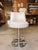 Contemporary Vanguard - unmarked - counter stool featuring a sleek, streamlined silhouette upholstered in smooth light...