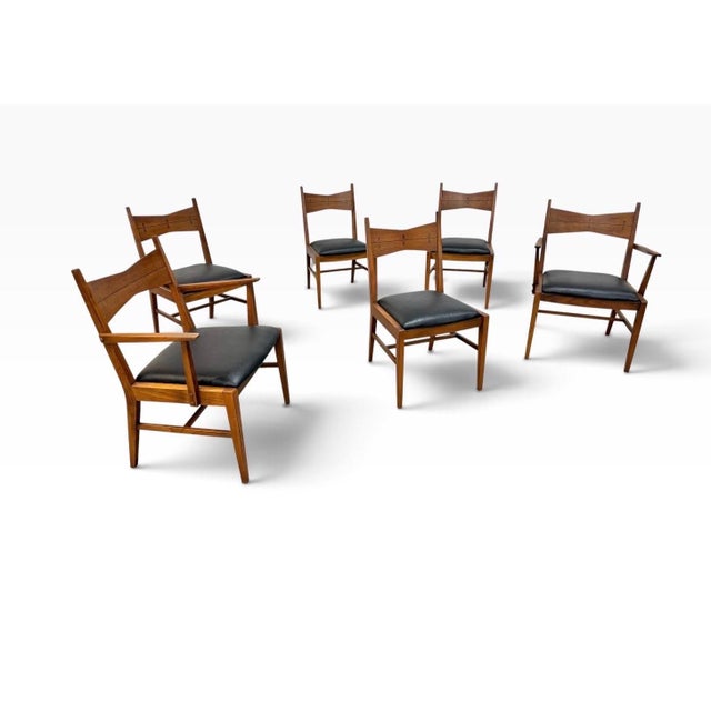 A striking set of six Mid-Century Modern Lane “Tuxedo” dining chairs, circa 1960s. Crafted in warm walnut, these chairs...