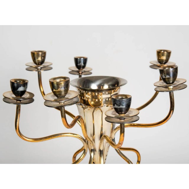 This silver plated brass candleholder with an incorporated vase was designed in the 1980s by Borek Sipek.